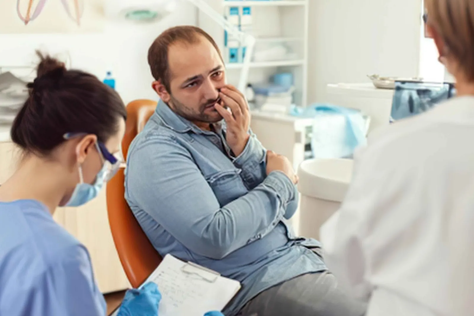 Patient discussing dental anxiety with a dentist before root canal treatment