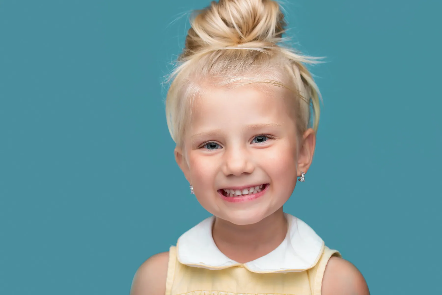 Friendly children's dentist with young patient